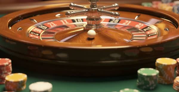The image features a vibrant casino roulette wheel set against a green felt surface, with colorful chips scattered around it, inviting players to engage in thrilling casino games. This scene captures the excitement often found in crypto casinos, where players can enjoy a variety of games and experience the thrill of online gambling.
